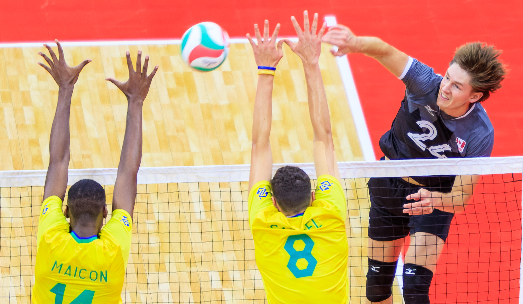 Canada wins in five sets to top Group B